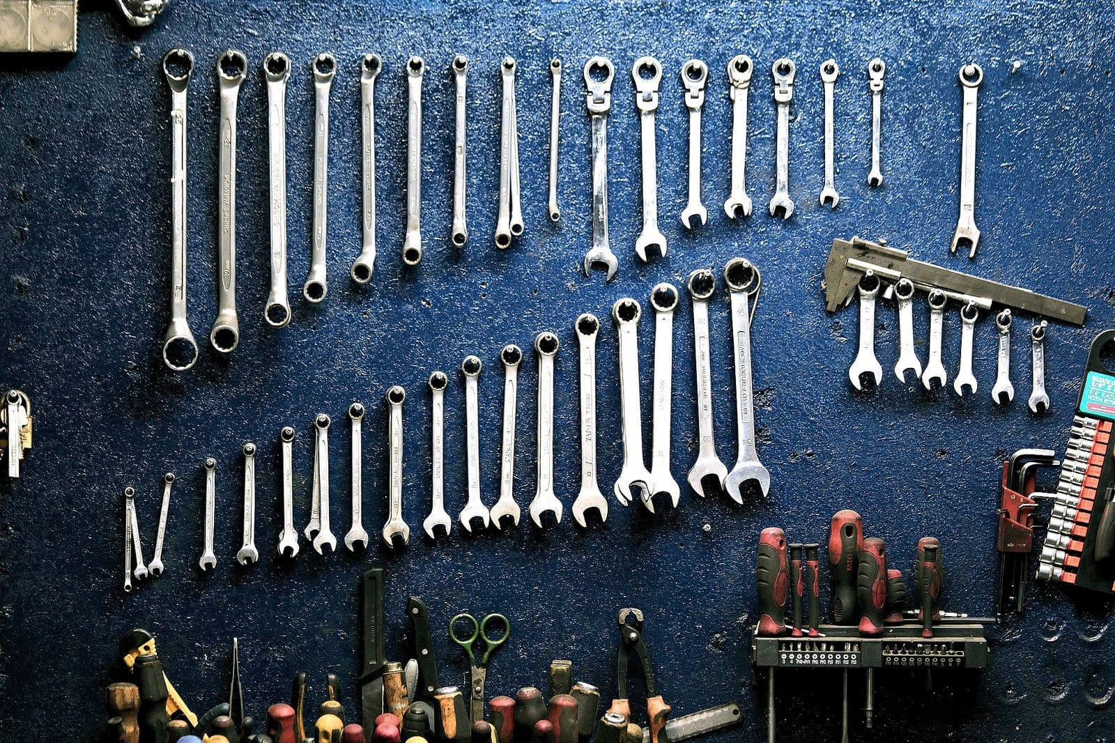 Organised wall of professional spanners, calipers and workshop tools